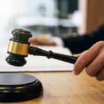 Gala Meltdown: $1M Bill Goes Missing Judge's hand holding a gavel over a sound block