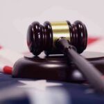 Judge Slams Brakes On Hormones Judge’s gavel on a base over an American flag