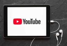 FTC vs YouTube: Rigged Rules Exposed? Tablet displaying YouTube logo with wired earphones