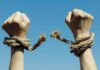 Oscar Rebel Cuffed During UN Chaos Hands breaking free from rope bindings against a clear blue sky