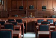 Discipline Looms After Explosive Hearing Empty courtroom with wooden benches and judge's bench
