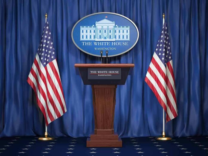 shutterstock_1159933525 White House press podium with microphones and two American flags