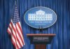 White House press briefing podium and US flag