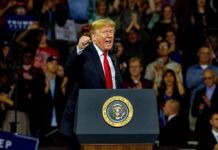 Unlikely Alliance: Trump–Schiff Woo Hollywood man speaking at a podium during a rally
