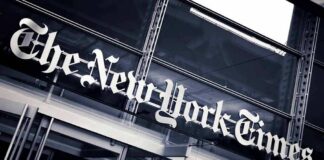 The New York Times sign on a glass building facade