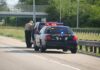 Highway Stop Exposes Gold Shakedown Police officer conducting a traffic stop on a highway