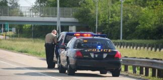 Police officer conducting a traffic stop on a highway