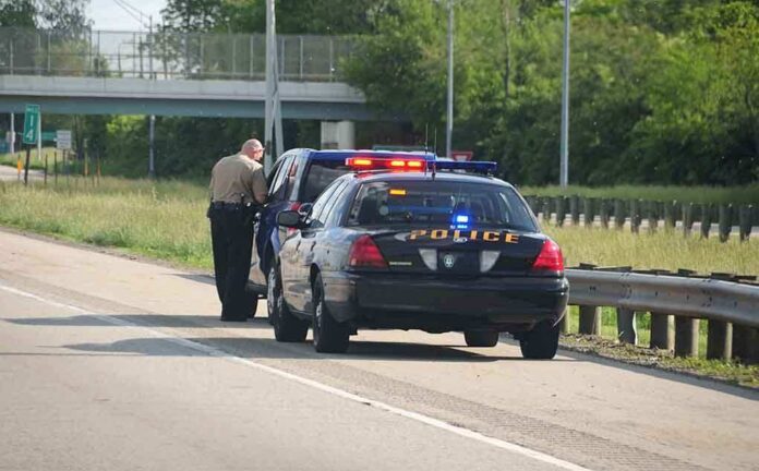 shutterstock_12763549 Police officer conducting a traffic stop on a highway
