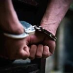 hands in handcuffs behind back