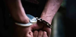 hands in handcuffs behind back