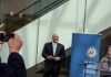 Grieving Dad Blasts Democrats at Hearing – Watch This Man in a suit at a public event near a blue banner