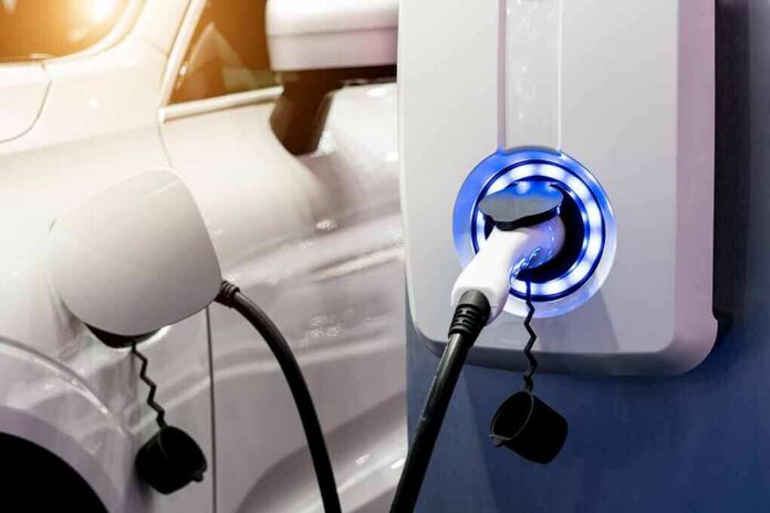 shutterstock_1349159210 Electric vehicle charging at wall-mounted EV charger