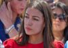 Why AOC ‘Lied’ Story Keeps Returning woman in red top at an outdoor event