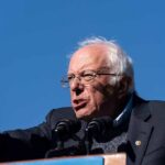 Nuclear-Level Penalties For Building AGI Bernie Sanders speaking at a podium outdoors