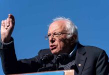 Nuclear-Level Penalties For Building AGI Bernie Sanders speaking at a podium outdoors