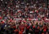 Midterm Stunt: $5,000 On The Line Speaker at podium addressing large crowd in arena