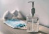 Pandemic Loan Purge Stuns Borrowers Hand sanitizer bottle beside face masks on a table