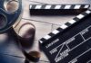 California Buys Back Hollywood Work Film reel and clapperboard on wooden surface