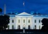 Congress Or Trump? Ballroom Fight Deepens White House illuminated at dusk with flagpole and columns