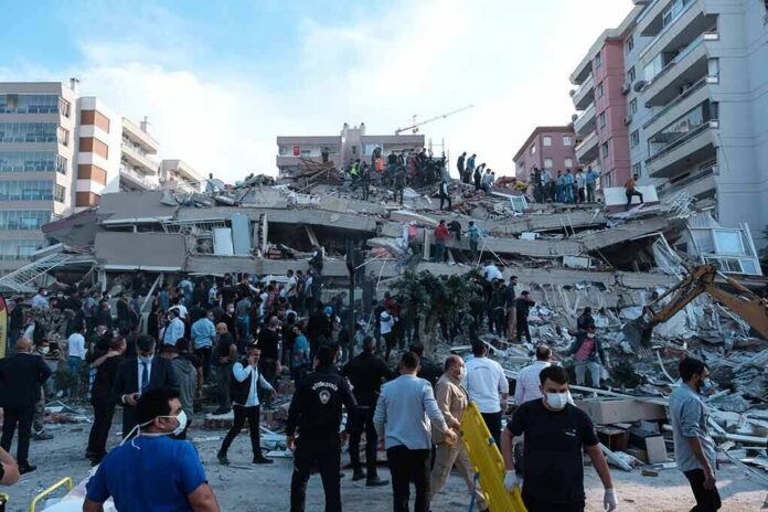 shutterstock_1845063010 Rescue workers and civilians on collapsed building after earthquake