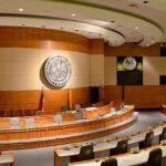 Dem Gamble On Abortion Timing Backfires? Interior view of a government chamber with wooden paneling and seating