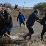Brain-Eater Strikes After Summer Swim Group of people wading through a shallow river