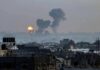Plan to Empty Gaza Stuns UN Cityscape with distant explosions and rising smoke