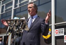 Newsom’s Kill Switch Sparks Tech Panic Gavin Newsom speaks at a press conference with microphones outside a building