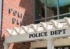 Campus Tragedy Sparks Urgent Probe Police department entrance with pergola and brick wall