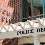Campus Tragedy Sparks Urgent Probe Police department entrance with pergola and brick wall