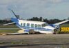 Mystery Crash Freezes Busy City Airport Damaged blue and white small airplane on an airport runway