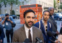 Media Ban Showdown: Trump Vs. NYC Mayor Zohran Mamdani speaking to reporters on a city sidewalk