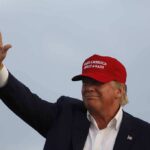 Trump-Xi Summit Produces A Trade Deal Donald Trump waving in a red cap