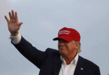 Trump-Xi Summit Produces A Trade Deal Donald Trump waving in a red cap