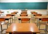 School Cash Twist Splits Democrats Empty classroom with rows of wooden desks facing a large chalkboard
