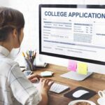Med School Rocked By DOJ Findings Student completing a college application on a desktop computer