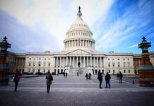 United States Capitol building with visitors on the plaza