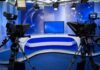 Talarico Confronted Over His Past Claims A television studio setup with cameras and a blue backdrop