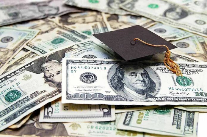 Graduation cap on a pile of US dollar bills