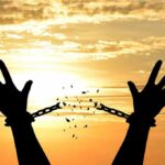 Overnight Turnaround After Trump Calls Putin Silhouette hands breaking chains at sunset