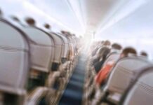 Stabbing Turns Routine Flight Into Nightmare Airplane cabin aisle with blurred passengers and seats