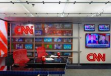 France Riots Spark CNN Brawl CNN newsroom set with red chairs and multiple TVs