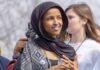 Ilhan Omar wearing a black headscarf at an outdoor event