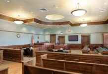 Idol Pastor’s Double Life Explodes Empty courtroom with wooden benches and judge's bench