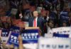 Donald Trump speaks at a rally, giving two thumbs up