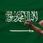 Missiles Rock Riyadh – Flights Paralyzed Hands breaking chains over a green flag with Arabic script and a sword