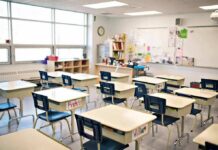 Empty classroom with rows of student desks and chairs