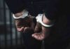 hands in handcuffs behind back