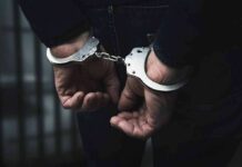 Wage Theft Jail Term Shocks California hands in handcuffs behind back