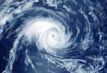 Category 3 Beast Zeroes In Hurricane swirling over the ocean from above